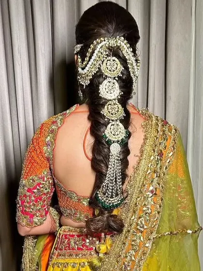 Another view of the Kundan hair accessory, showing how it beautifully complements an embroidered lehenga.