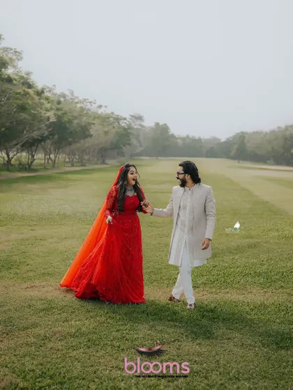 Another stunning photo of the happy couple. The groom's classic sherwani and hairstyle were designed to complement the beautiful outdoor setting.