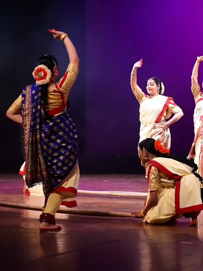 A performance moment from 'Mix & Match', where dancers use a simple bamboo stick to represent the loom. The choreography integrates movements that evoke the process of weaving, spinning, and dyeing.