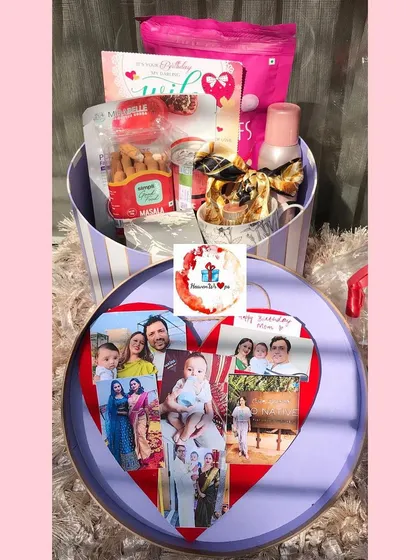 A special hamper for mom. This round box opens to reveal a heart-shaped photo collage on the lid and is filled with snacks and self-care products.