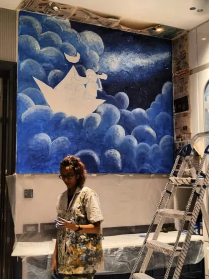 Me standing with the work-in-progress of the stargazer mural. It's a joy to bring such imaginative concepts from a sketch to a large-scale piece of art.