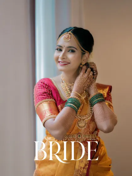 A classic bridal portrait, capturing the bride's happy smile as she gets ready for her big day.