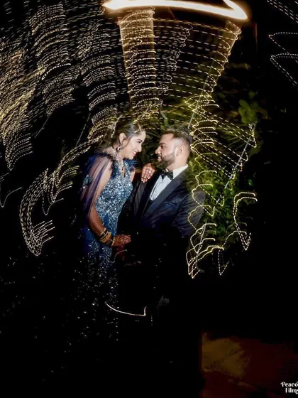 An artistic and creative portrait using a slow shutter speed to create mesmerizing light trails around the couple.