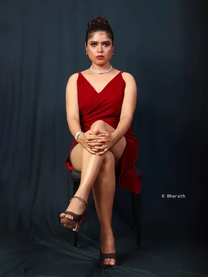 A powerful and modern studio portrait. The simple dark backdrop and focused lighting create a dramatic, high-fashion look perfect for a portfolio.