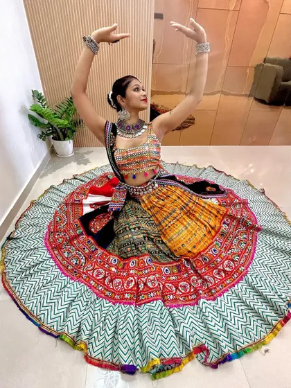 A dance pose showing the beautiful movement and design of this traditional Garba outfit, perfect for any Navratri celebration.