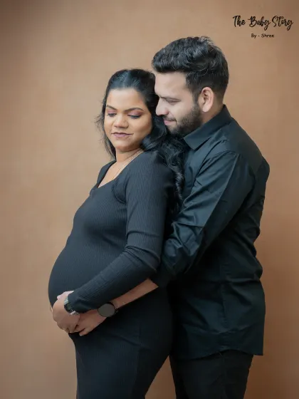 A classic maternity pose with the partner embracing the mom-to-be from behind. This pose is all about support, love, and shared anticipation.