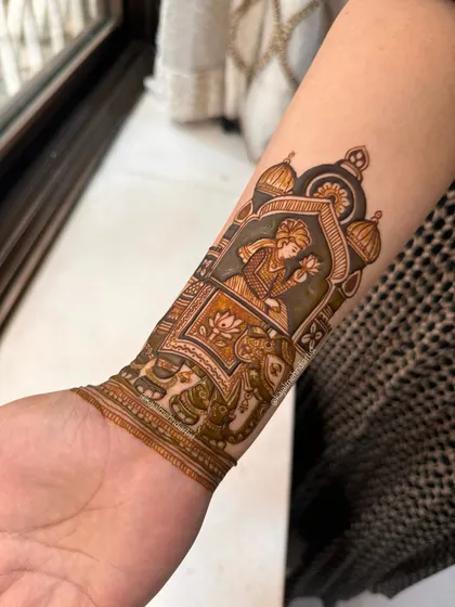 A close up of the groom on an elephant. The details in the groom's attire and the elephant's decoration are what make this design so special.