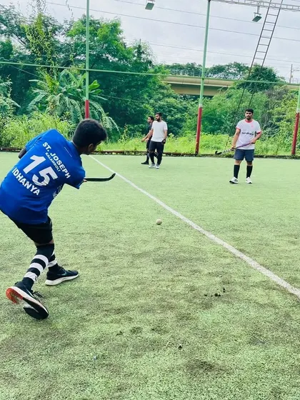 A junior player in a St. Joseph jersey practices his shooting technique. We work with players from various schools, uniting them under the banner of Hockey Navi Mumbai.