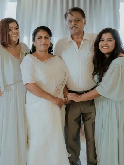 A heartwarming family photo where I had the pleasure of designing the women's pastel gowns, creating a soft and unified aesthetic for their special day.