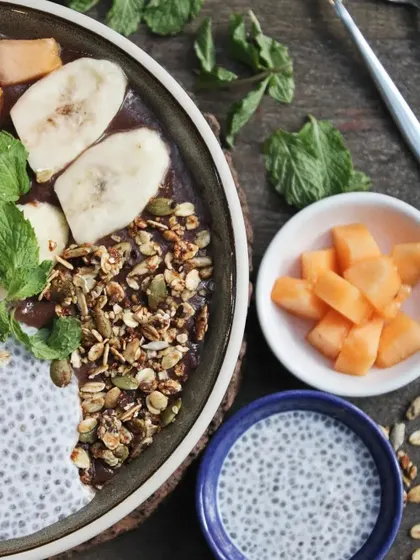 A close-up of our smoothie bowl, showing the texture of the crunchy granola, creamy chia pudding, and fresh fruit. It's a feast for the eyes and the body.