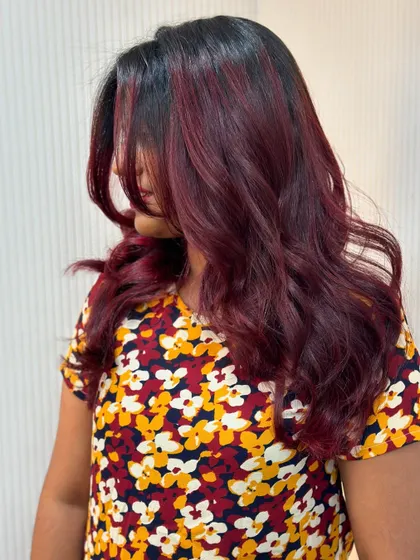 A side view of the cherry red balayage, showing how the color frames her face.