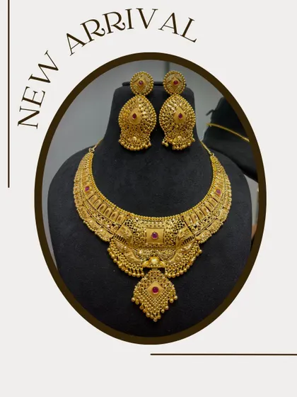 A new arrival in my store, this is a heavy, broad necklace with intricate work and ruby-colored stones. It's a perfect bridal or festive wear piece.