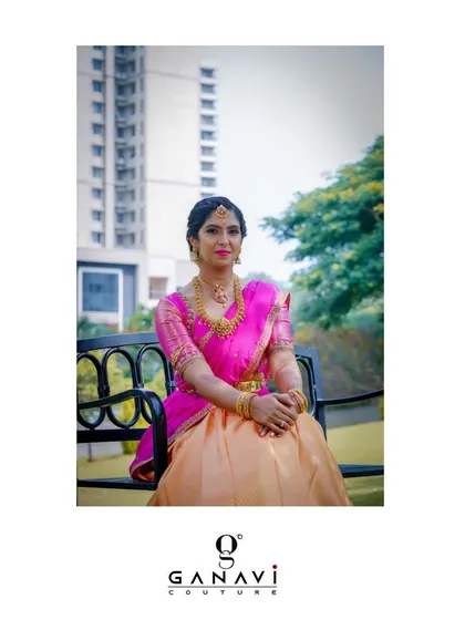 Our client Shalini looks gleaming in a custom half-saree attire. The bright pink and peach combination is perfect for a festive occasion, making her sparkle and shine.