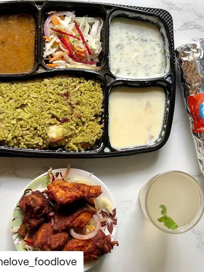 Here's a look at a perfect work-from-home lunch. This spread includes a Thuppangadi Chicken Biriyani meal tray, our Bengaluru style chicken kebab, and a chicken ghee roast roll. It's a complete, flavourful meal delivered right to you.