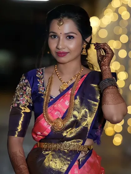 A candid moment of the bride adjusting her hair. The soft, romantic hairstyle and makeup are perfect for a reception.