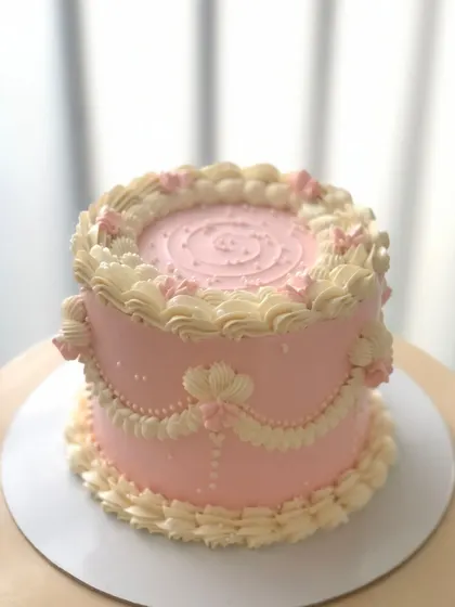 A soft pink vintage Lambeth cake, showcasing the delicate and precise piping work that defines this classic style.