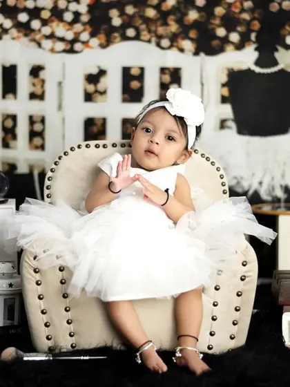 A little fashion star in the making. This glamour-themed shoot features a makeup vanity, pearls, and a chic black and white set.