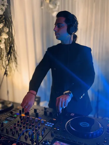 Pose on point. A stylish shot of me at the console, ready to drop the next track for a party that spans Bollywood, EDM, and house music.