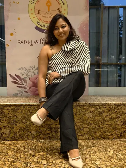 A relaxed and confident seated pose. Even when I am not on stage, I carry the poise and presence of a host.