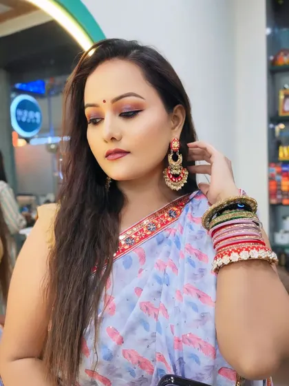 This angle shows the beautiful earrings and bangles that complete her party look.