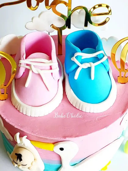 A close-up of the handcrafted, edible baby shoes. These little details are what make a custom cake so special.