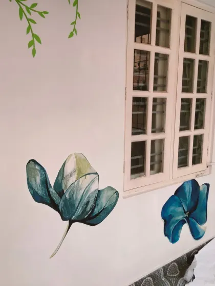 The floral mural creates a peaceful and natural ambiance inside the room.