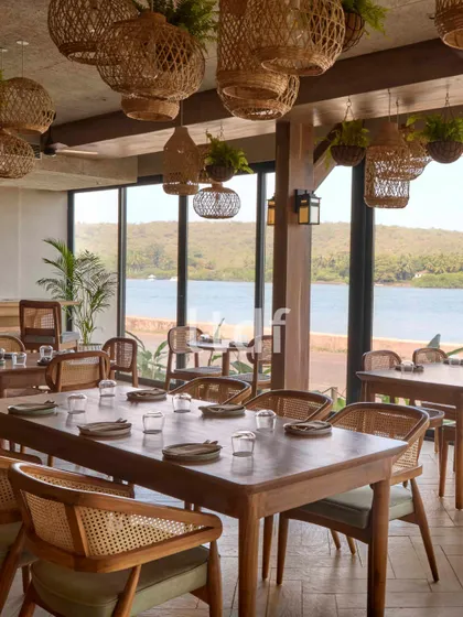 For this waterfront cafe, our design narrative was guided by serenity and nature. We used warm wood finishes and handcrafted rattan elements to evoke a sense of quiet, coastal luxury. The space is flooded with natural light, seamlessly blending the indoors with the lush landscape outside.