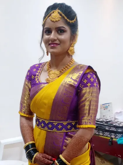 Another angle of this stunning bridal look, focusing on the fit of the blouse and the drape of the saree. Every detail is important for creating a picture-perfect appearance.