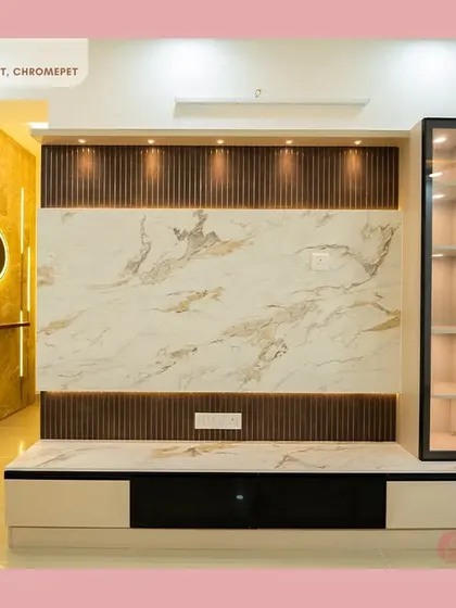 A closer look at the stunning TV unit in our Chromepet project, featuring a marble-finish panel, dark wood fluting, and a glass display cabinet with internal lighting.