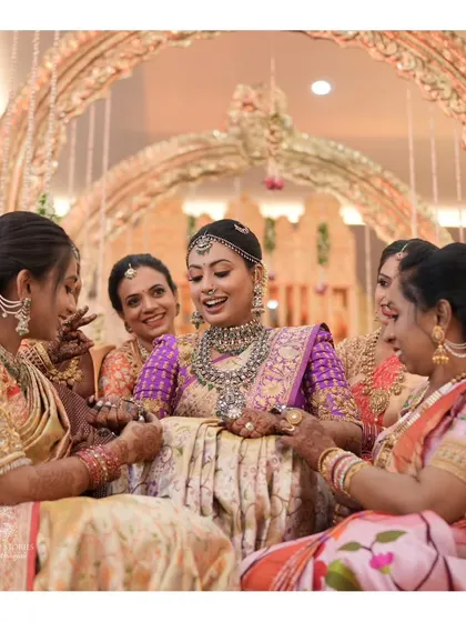 A joyous moment from Nidhi's wedding celebrations. Her makeup is vibrant and celebratory, perfectly matching the happy atmosphere of the event.
