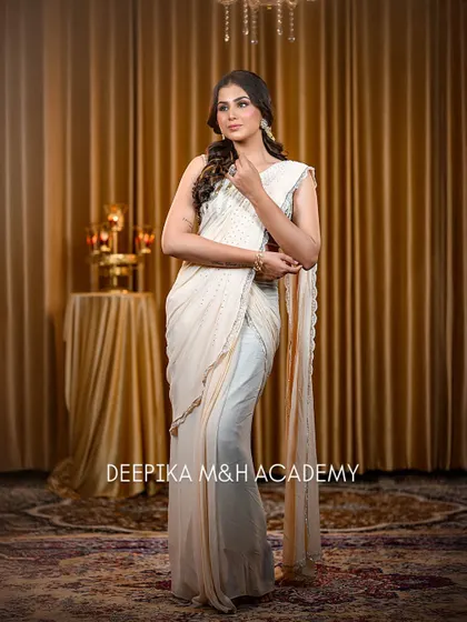 The model strikes a pose, showing off the elegant drape of the saree and her confident attitude.