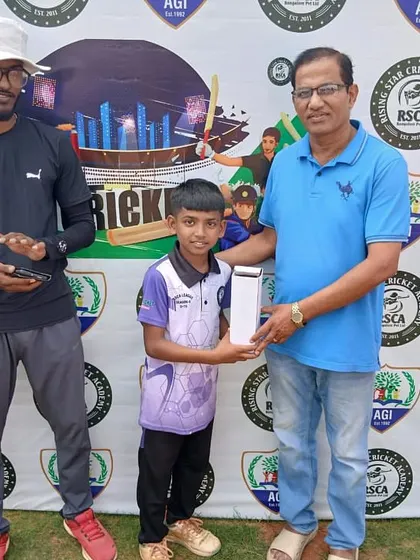 A young player receives his award from a guest during the RSCA League presentation.