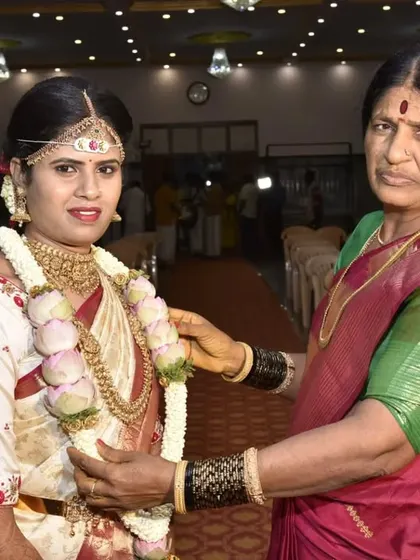 A precious moment between the bride and her mother. The bride's makeup is traditional and elegant, designed to make her feel beautiful while she shares these special memories.