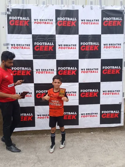 Another proud player with his award at the Independence Cup.