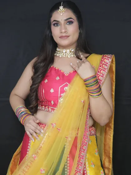 A close-up of the Haldi look, focusing on the vibrant makeup and the beautiful choker necklace.