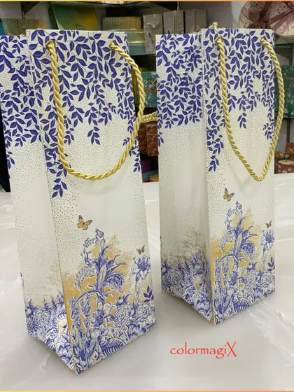Our custom-printed paper bags are perfect for smaller gifts or as part of a larger hamper. This elegant blue and white floral design with a gold rope handle is both beautiful and practical.