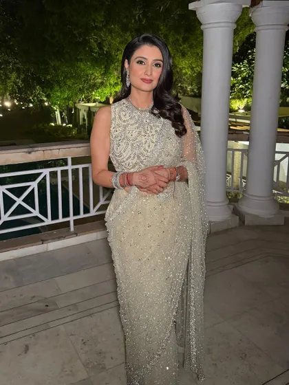 A full view of Shefali's sparkling reception look. The makeup is elegant and timeless, perfectly complementing her stunning embellished saree.