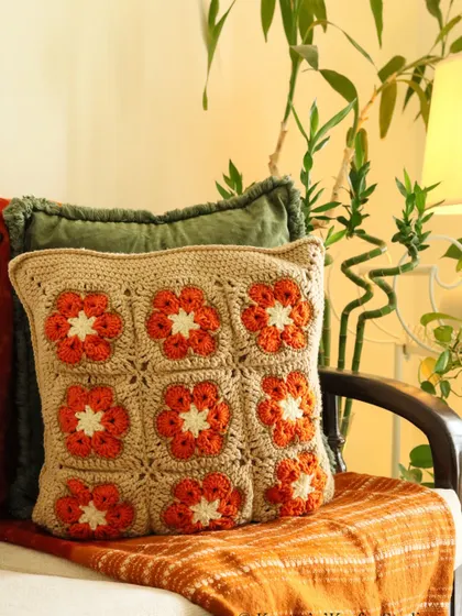 This version of the Sundowner cushion features simple yet bold orange flowers, perfect for a subtle pop of colour.