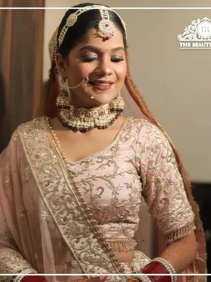 A close-up of the bride's soft glam makeup. The focus is on the shimmering eyeshadow and the radiant, dewy finish of her skin.