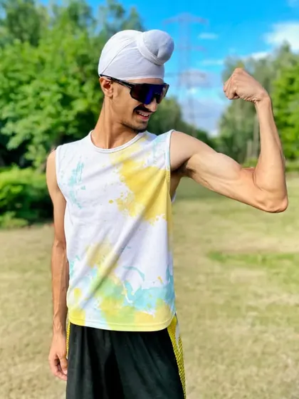 I train so hard that I become unstoppable. Flexing after a hard run, showcasing the lean, powerful physique that is the result of a dedicated athletic lifestyle.