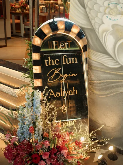 A personalized welcome sign for Aaliyah and Shane's Mehendi. The elegant script and floral arrangement set a warm and inviting tone for the event.