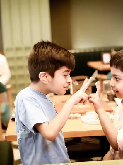 A playful moment between two friends at a party. We believe in capturing the fun and games that are a huge part of any kid's birthday celebration.