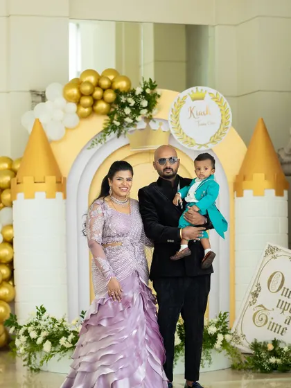 A beautiful family portrait in front of the custom-built castle entrance we designed for their son's first birthday. The gold and white palette created a classic and elegant fairytale look.
