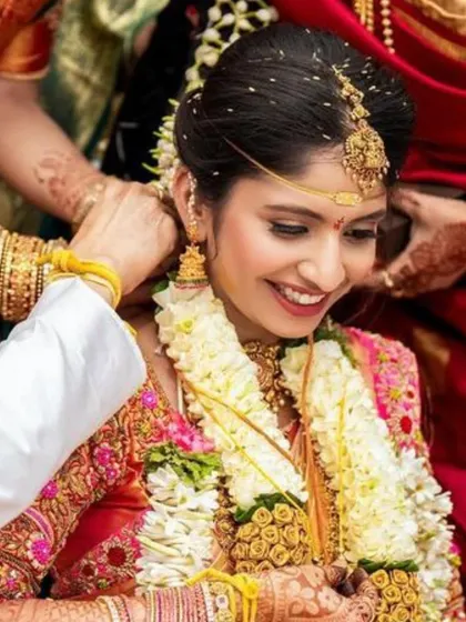 A candid moment of pure happiness. This photo captures the bride's radiant smile, enhanced by a natural makeup look that is perfect for her wedding ceremony.