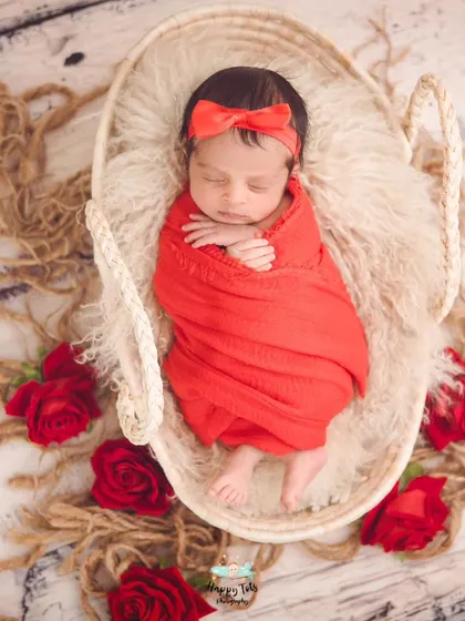 A bold red swaddle makes this beautiful baby pop. We use simple, focused setups to ensure your baby is always the star of the show.