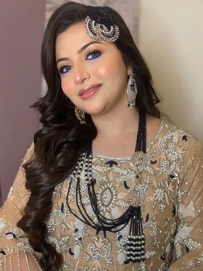 This client looks absolutely regal. The bold makeup and statement jewelry create a look that is powerful and beautiful.