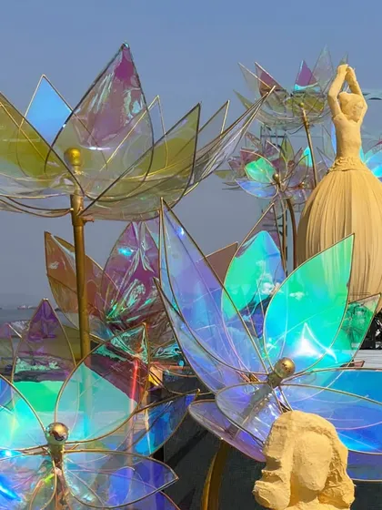 A close-up of the iridescent lotus flowers and a 'dancing doll' sculpture, showcasing the months of planning and conceptualizing that went into this unique design.