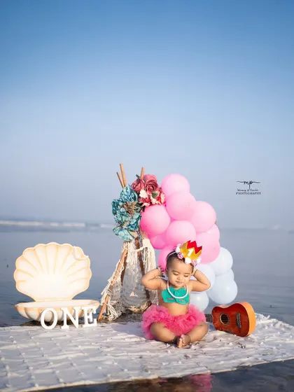 A playful moment from the mermaid-themed birthday shoot, as the little one adjusts her crown. This candid shot captures her personality and the fun of the session.