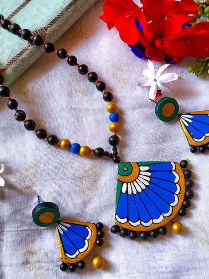A simple and elegant fan-pendant necklace in blue and green with a black beaded chain.