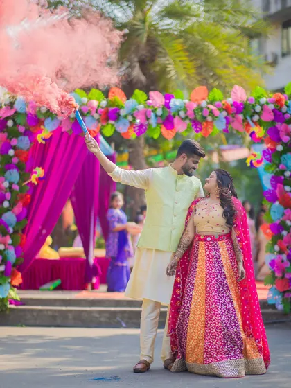 For Prachi and Sandeep's vibrant Mehendi, we used a smoke bomb to create this energetic and colorful shot. It's all about capturing the fun and excitement of your pre-wedding celebrations in a dynamic way.